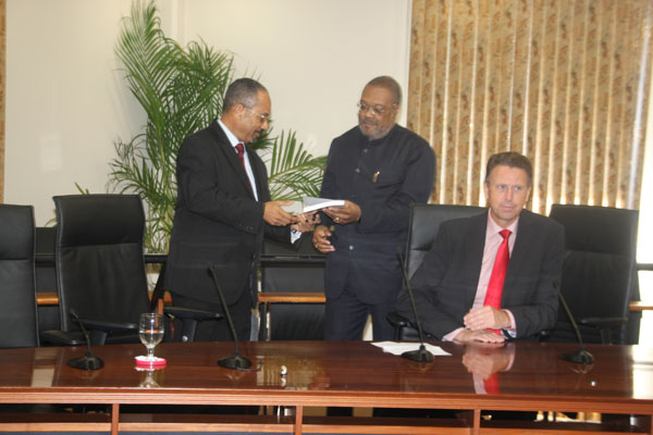 Attorney General Dick Piar handing over the CBA to Minister of Justice Roland Duncan. dpiarpresentscbatorduncan11012012