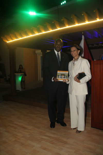Governor Eugene Holiday presenting the pictorial of the Royal Family Visit to the Prime Minister of St. Maarten, Sarah Wescot Williams. eholidayandswescotwilliams06012012