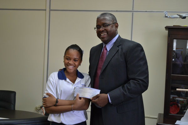 Left to right: Student Alyssa Sadheidha Clarke receiving her check from Hon. Minister Franklin Meyers. fmeyerspresentsfccacheque14012012