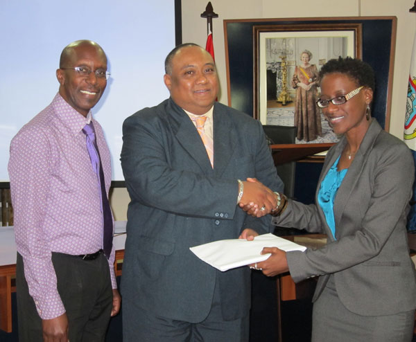 Presentation of the APS budget by APS Director Kendra Arnell (right) to Minister of Finance, Hiro Shigemoto – in the presence of APS Board Chairman, Franklyn Richards (left). (APS Photo) hshigemotoreceivesapsfirstbudget16012012