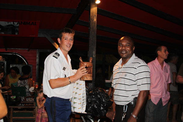 Richard York of the St. Maarten Police Force presents a token of appreciation to Brunet at the farewell party. richardyorkpresentsgifttostephenbrunet01072012