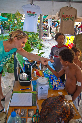 Stephanie Reed, Free Lance Grant Writer and Fundraiser at the Nature Foundation, interacts with young guests at the Spotlight St. Maarten Event. rockstarsfornaturefundraiser20012012