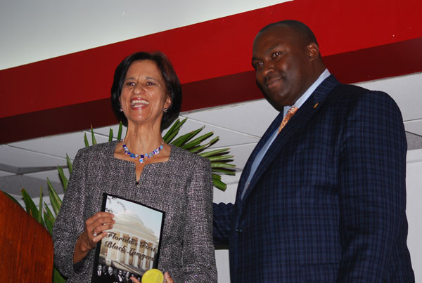 69th President of the National Bar Association Daryl D. Parks presents Prime Minister Hon. Sarah Wescot-Williams (left) with a book entitled “Florida’s First Black Lawyers.” (DCOMM Photo) swescotwilliamsreceivesbookfromdparks24012012