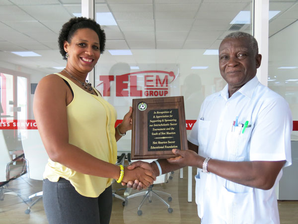 President of the St. Maarten Soccer Education Foundation, Mr. Keith Gittens, (right) presented a plaque of appreciation to TelEm Group Manager, Marketing & Sales, Grisha Marten, on behalf of the company during a brief presentation ceremony at the TelEm Group main building on Pond Island. schoolsoccer11052017