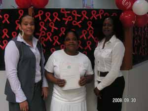 Arlette James of Scotiabank with lucky winner Liliane Baptiste and Lorraine Scot of the HIV/AIDS Programme Management Team.