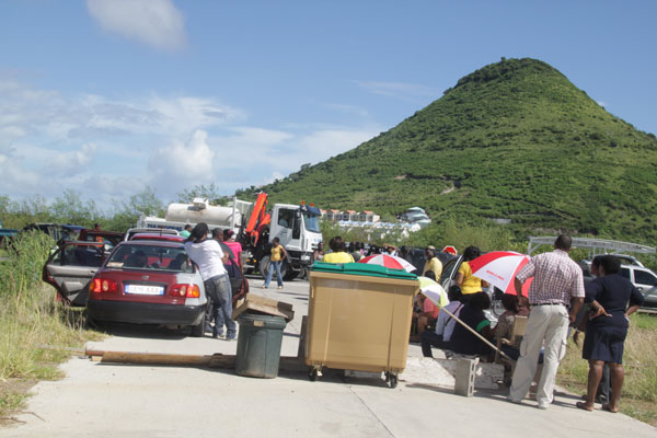 The entrance of Cuisine Central blocked by workers on Monday. ctosroadblock19092011