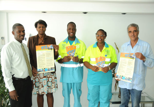 Left to right Ambulance Dept. Head Cylred Richardson, Chamber of Commerce Ruth Patrick, Ambulance Driver/Assistant Cherubin Coen, Nurse Natasha Carty, and Chamber of Commerce Vice President L. Quenniche holding up the 912 Ambulance Emergency Number posters and brochure which is part of the awareness campaign. (GIS Photo) emsmaterials27052010