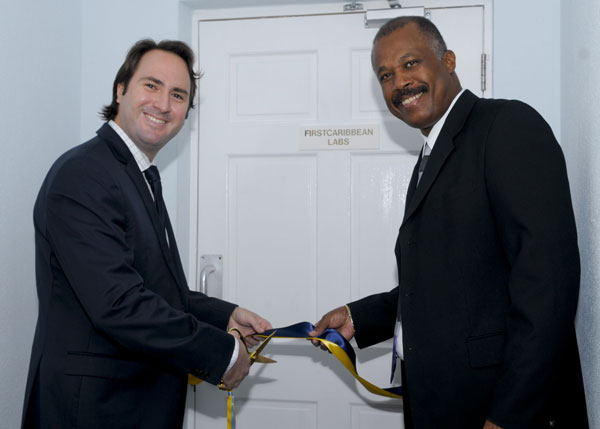 Daniel Farmer, Managing Director and Country Head of FirstCaribbean International Bank (left) and Professor Sir Hilary Beckles, Pro-Vice Chancellor and Principal of the Cave Hill Campus, cutting the ribbon to officially open a new section of the FirstCaribbean Suites. firstcaribbeansuite17022011