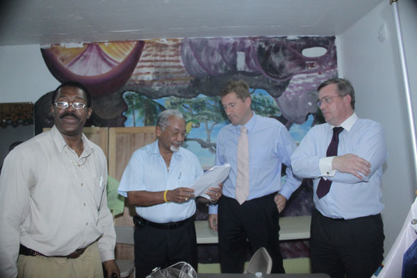 Attorney at law Martin Le Poole and Wim van Sambeek explaining the verdict to mediator Clarence Richardson as WIFOL president Theophilus Thompson looks on. lawyers08022011