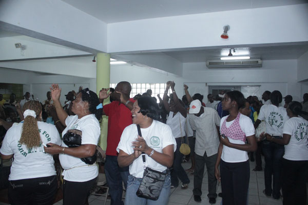 Workers singing and dancing as they praise God on Monday for their victory. pelicanworkersdancing08022011