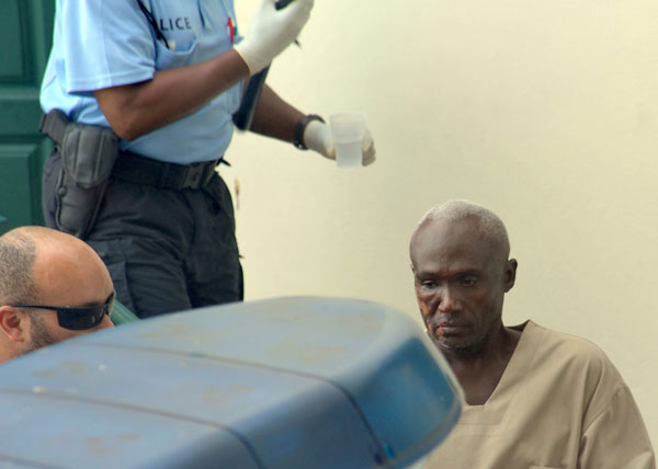 Murder suspect Robert Reid leaving Court of First Instance on Friday. robertreidleavingcourthouse09092011