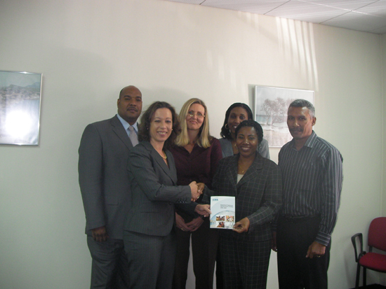 Maureen Blokland the section head National Accounts of CBS presents a statistical year book of CBS to Commissioner Maria Buncamper-Molanus. Also pictured from left to right is Miguel DeWeever, Jeanette Davelaar, Veronica Jansen-Webster and Mike Jacobs the section head Social Demographics for CBS. sany0409