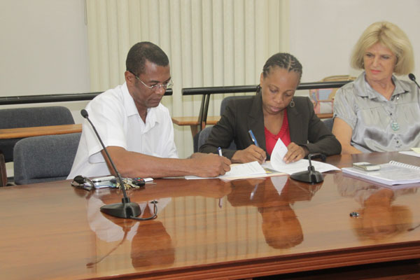 Minister of Education Rhoda Arrindell signing contract withTaliesin Construction for the new FBE school. signing09022011
