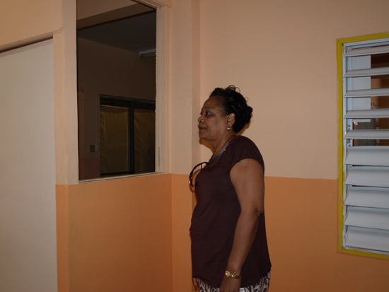 Director of Starlight Education Carmen Hodge looks at broken window space. starlight2