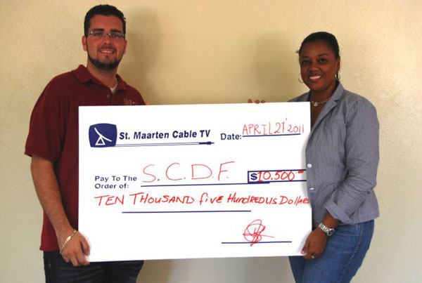 President Stuart Johnson with Managing Director of St. Maarten Cable TV Beulah Jonis. sxmcabletvdonatestoscdf05052011