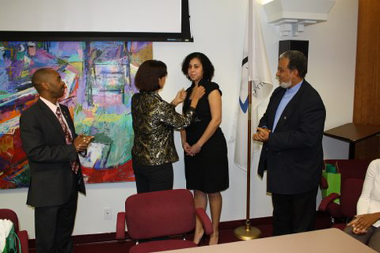 Left to right, Head of Study Financing Calvin Mardenborough, Commissioner Sarah Wescot-Williams pinning an emblem on St. Maarten Tallahassee Students Association President Dominique Hodge, who has been in charge of the aforementioned organization since December 2007; and Government representative Arthur Lugisse who liaisons between Tallahassee and St. Maarten. sxmtudssodge