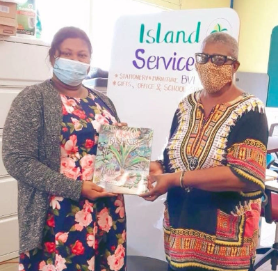 Patricia G. Turnbull (R), author of Ti Koko and Kush Kush, holding the storybook with bookseller Seema Omroa of Island Services, Ltd., Tortola. (P. Turnbull photo.) tkkschool16052021