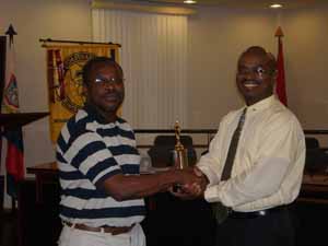 Area 6 Governor Rolando Tobias presents the winner’s trophy to CC Alfonso Blijden (left). 